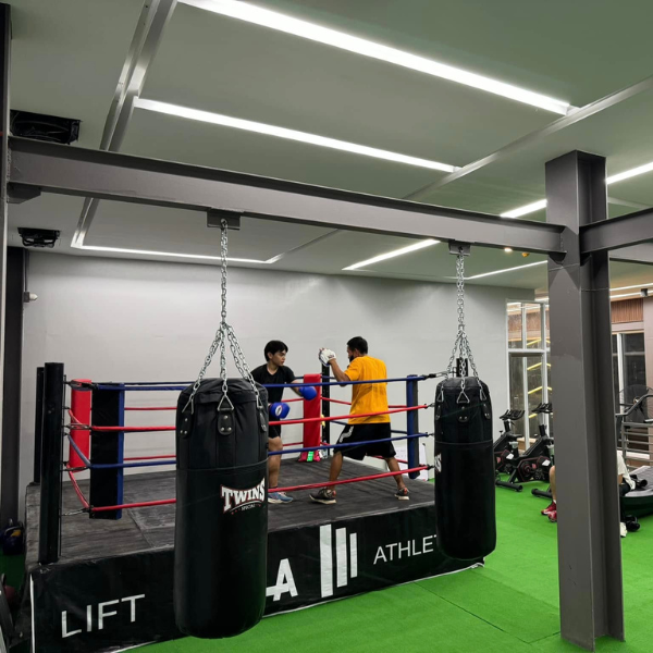Professional personal trainer coaching a client at a gym in Uptown CDO.